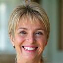 Photo of Sarah M., a vibrant woman in her late 40s smiling